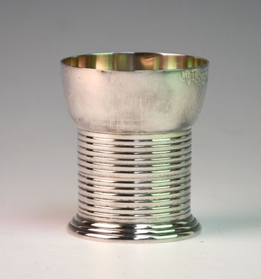 a silver cup that is sitting on a table