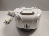 a white object on a table with a charger and a cord