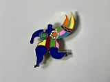 a close up of a pin with a person holding a banana
