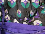 a purple bag with purple and green designs on it