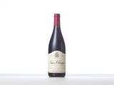 the bottle of red wine is sitting on the table