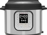 a close up of an electric pressure cooker on a white background