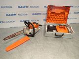 a close up of a chainsaw and a tool case on a table