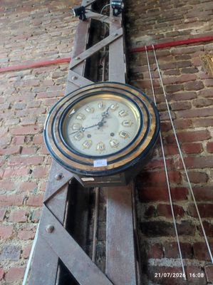 a clock hanging on the side of a brick wall