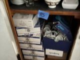 a cupboard full of plates and bowls in the kitchen
