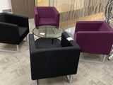 three chairs and a table in the middle of a room