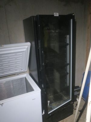a refrigerator and a freezer sitting in a room