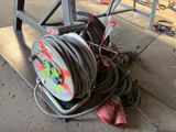 a hose that is sitting on the ground next to some wires