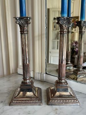 two candles that are sitting on a marble table