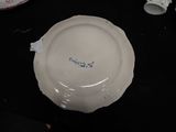 a white plate with blue writing on it sitting on a table