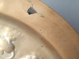 a metal bowl with a design on it