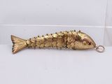 an image of a gold fish keychain on a white surface