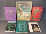 several books are lined up on a table with a gray background
