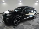 the black suv is parked in the garage on a checkered floor
