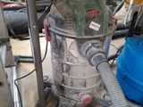 a vacuum that is sitting on the floor next to a blue bucket