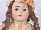a doll that is wearing a hat with a flower on it
