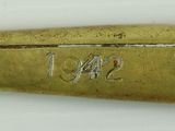 a gold plated spoon with the word sno 1 on it
