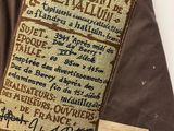 an image of a brown jacket with a label on it