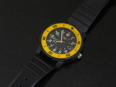 a close up of a watch on a black surface