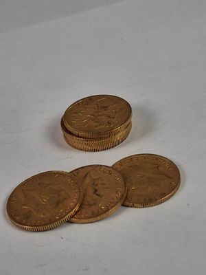 a pile of coins sitting on top of a white table