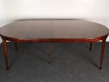 an oval dining table with two leaves on the top