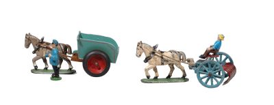three figurines of horses pulling a wagon and a man on a horse drawn carriage