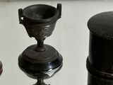 three different types of vases sitting on a table