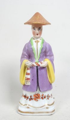 une figurine représentant une femme coiffée d'un chapeau et tenant un panier