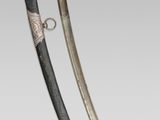 pair of swords with silver and black paint on them on a gray surface