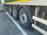a green and yellow semi truck parked in a parking lot