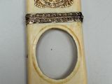 a small piece of ivory with a ring on top of it