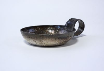 a close up of a small bowl on a white surface
