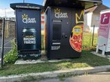 a small pizza kiosk on the side of the road