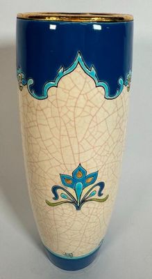 a blue and white vase with a blue flower on it