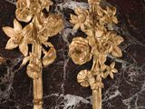 two gold flowers on the wall next to each other