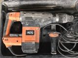 an orange and black electric drill in a black case