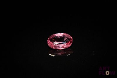 a pink diamond on a black surface