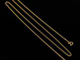 a gold chain with a clasp and a clasp on a black background