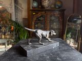 a statue of a dog that is standing on a table