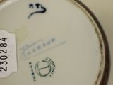 a close up of a plate with a tag on it