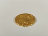 a gold coin with a picture of a man on it