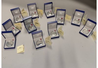 a lot of silver rings in boxes on a table