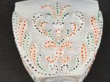 an image of a white vase with an orange and green design on it