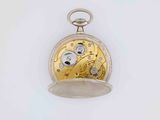 a silver and gold pocket watch on a white surface