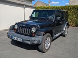 a black jeep that is parked in a parking lot