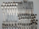 a lot of silver spoons and spoons on the table