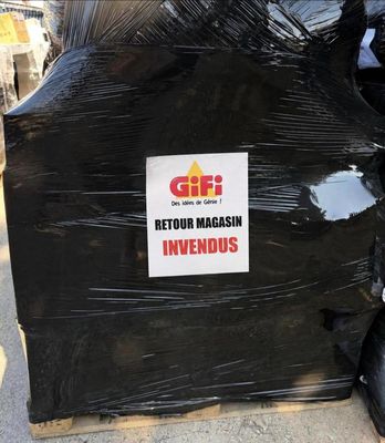 a pile of garbage on the street with a sign on it