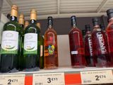 many bottles of wine on the shelf in the store