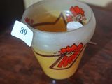 a glass cup that is sitting on a table
