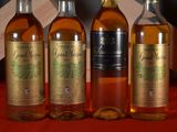 four bottles of whiskey are lined up on a red table